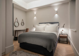 An interior design shot of a contemporary grey bedroom