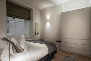 An interior design shot of a contemporary grey bedroom