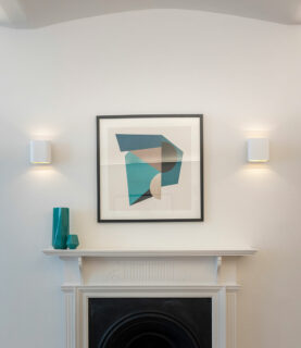 An image of a fireplace with art