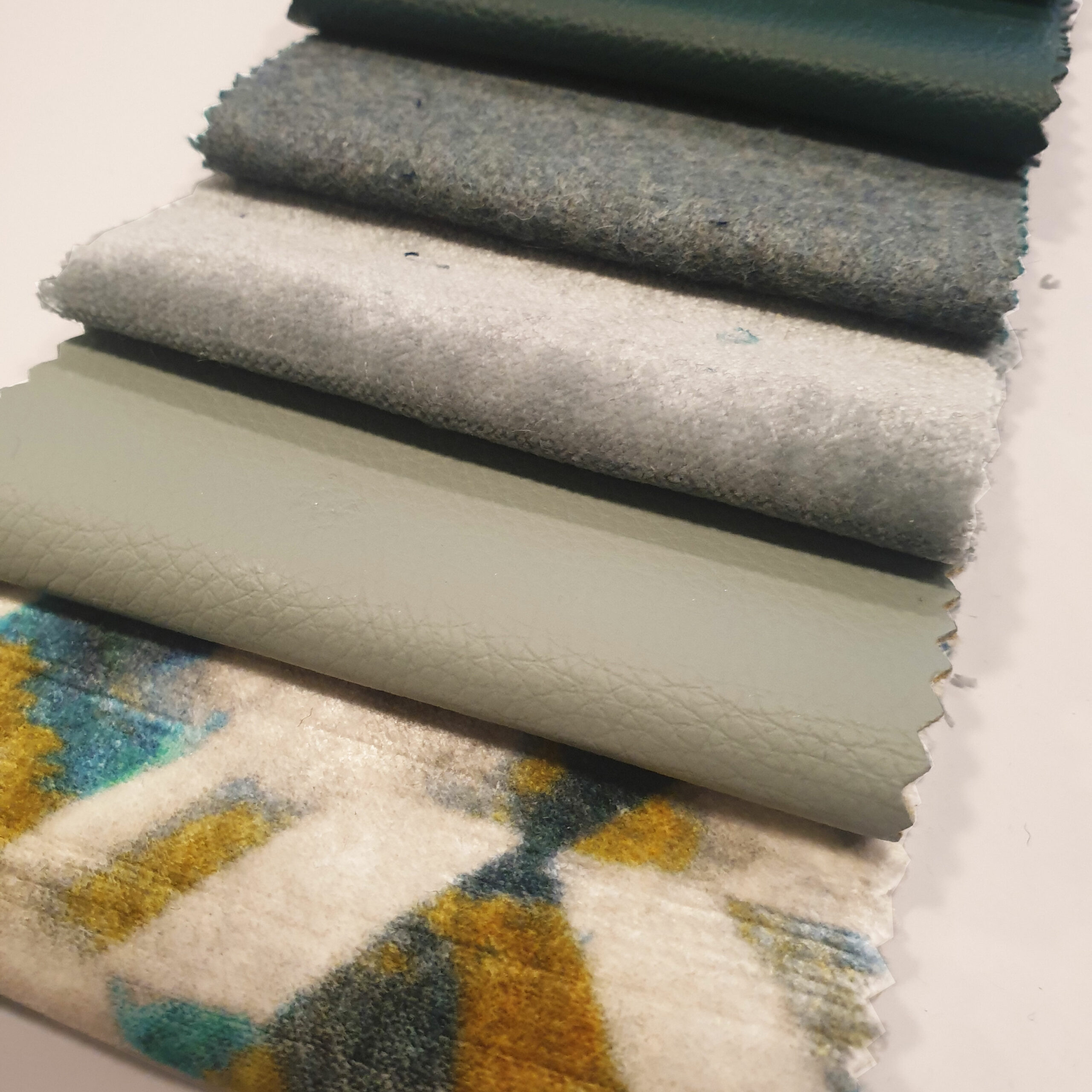 selection of fabrics in greens & sage colours